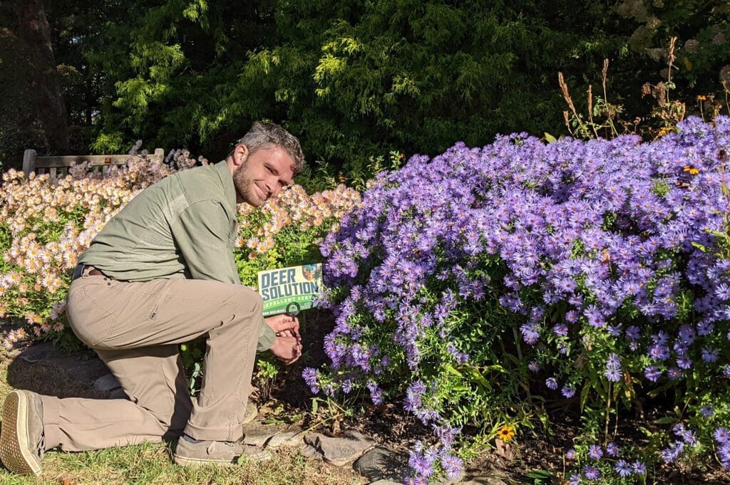 Deer Repellent Solution guy adding signage